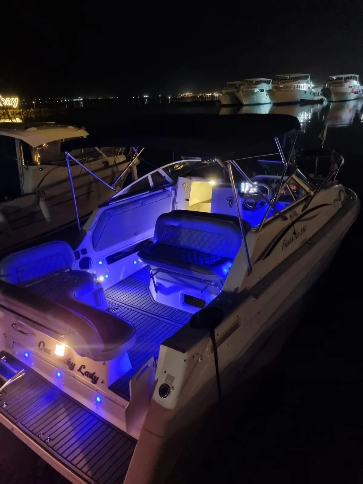 One Lucky Lady lit up with blue deck lighting after dark