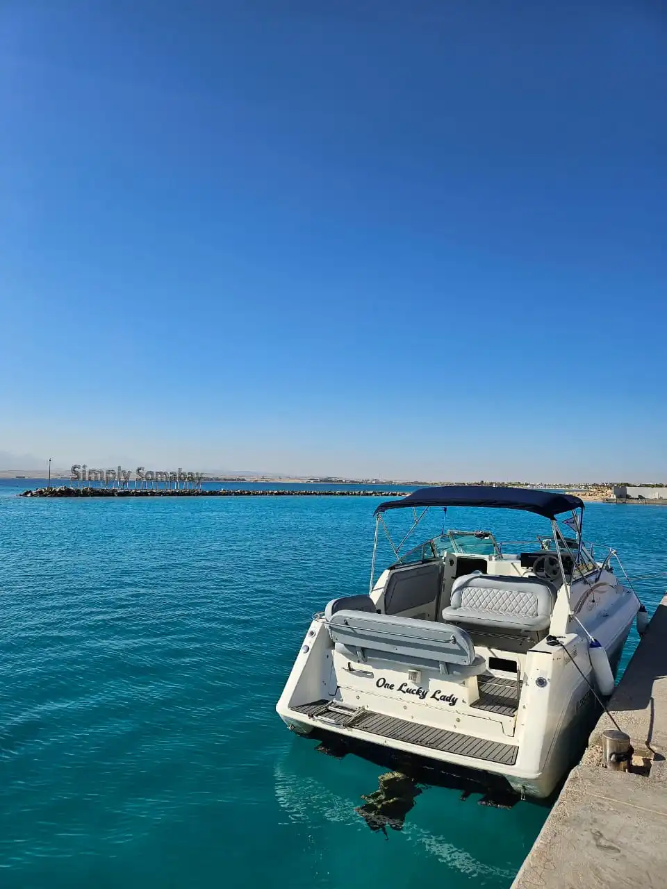 One Lucky Lady moored at Soma Bay marina with the Red Sea behind