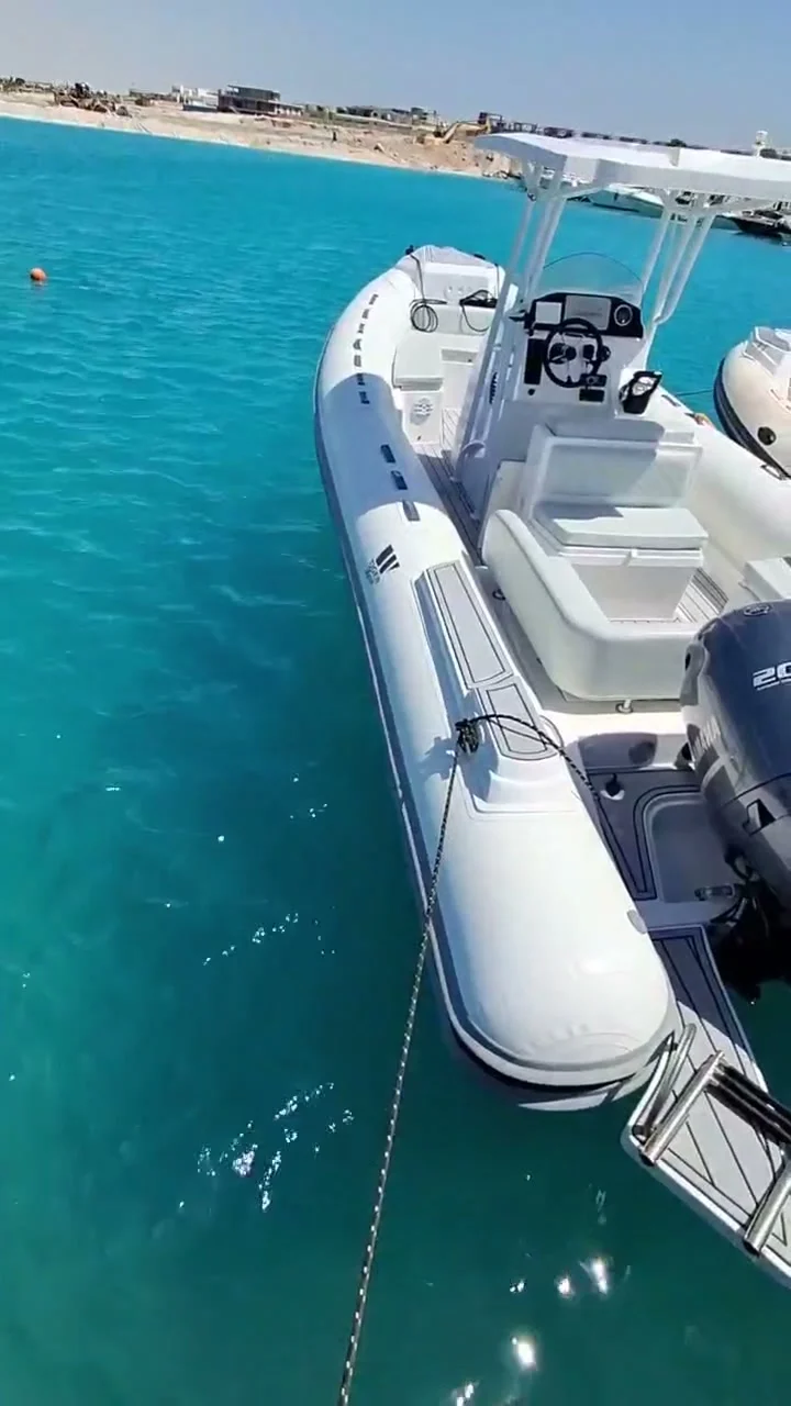 The bow of the private speedboat over clear shallows